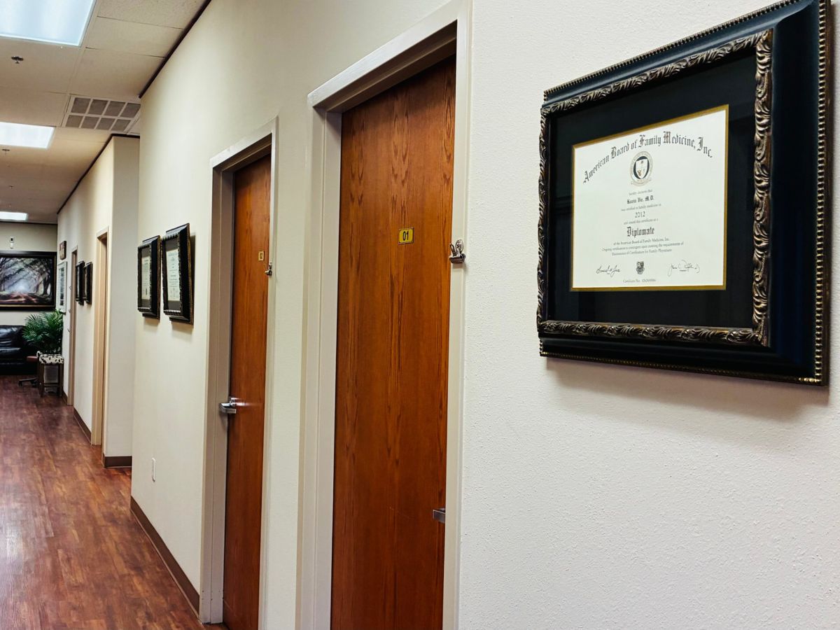 Clinic hallway with Dr. Vo's board certificate